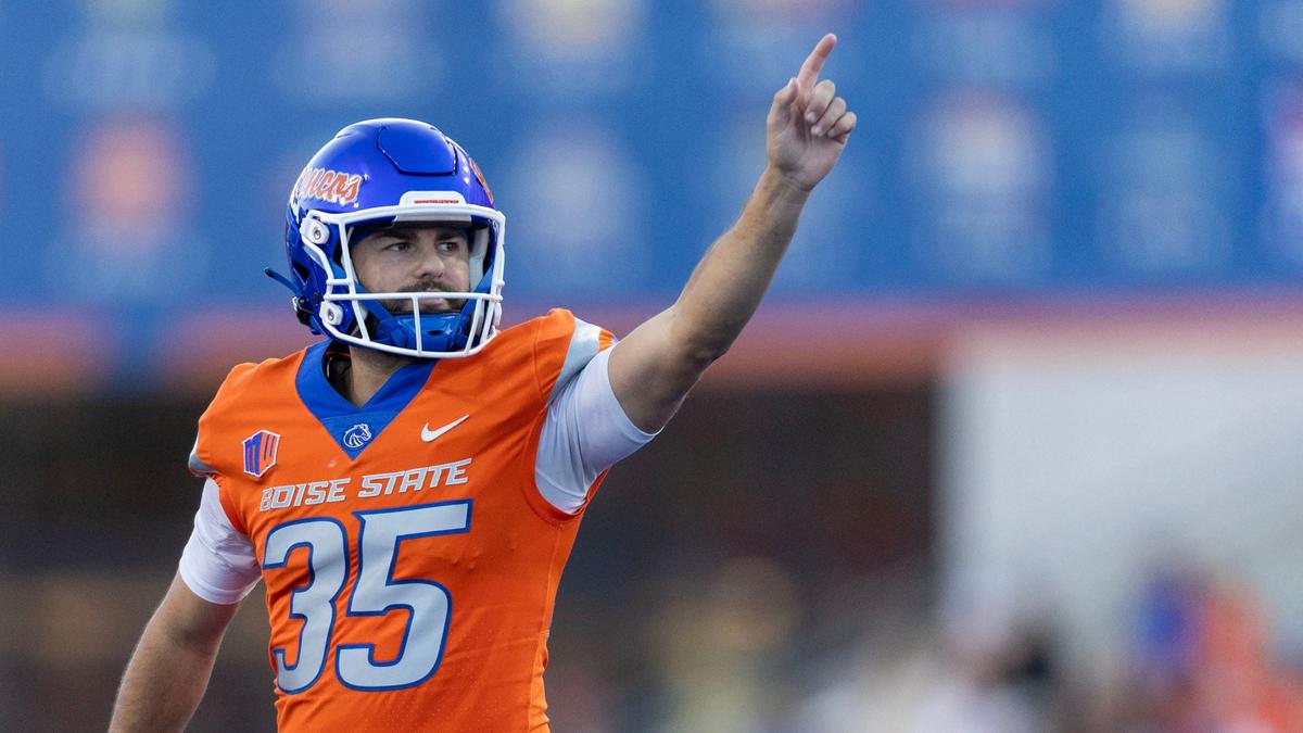 Boise State kicker Jonah Dalmas reacts to cheering Bronco fans after adding an extra point to the 62-30 win over Mountain West foe Utah State on Saturday at Albertsons Stadium.