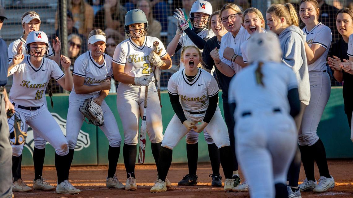 Kuna teammates wait at home plate to celebrate senior Brylin Field’s two-run home run in the sixth inning of the Kavemen’s 12-8 win over Rocky Mountain in the 5A District Three semifinals on Wednesday at Eagle High School.