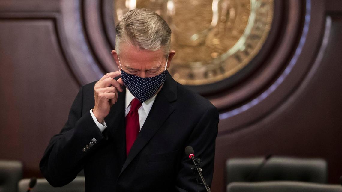 Gov. Brad Little begins to remove his protective mask before updating the media Sept. 3 on Idaho’s latest responses to the coronavirus pandemic.