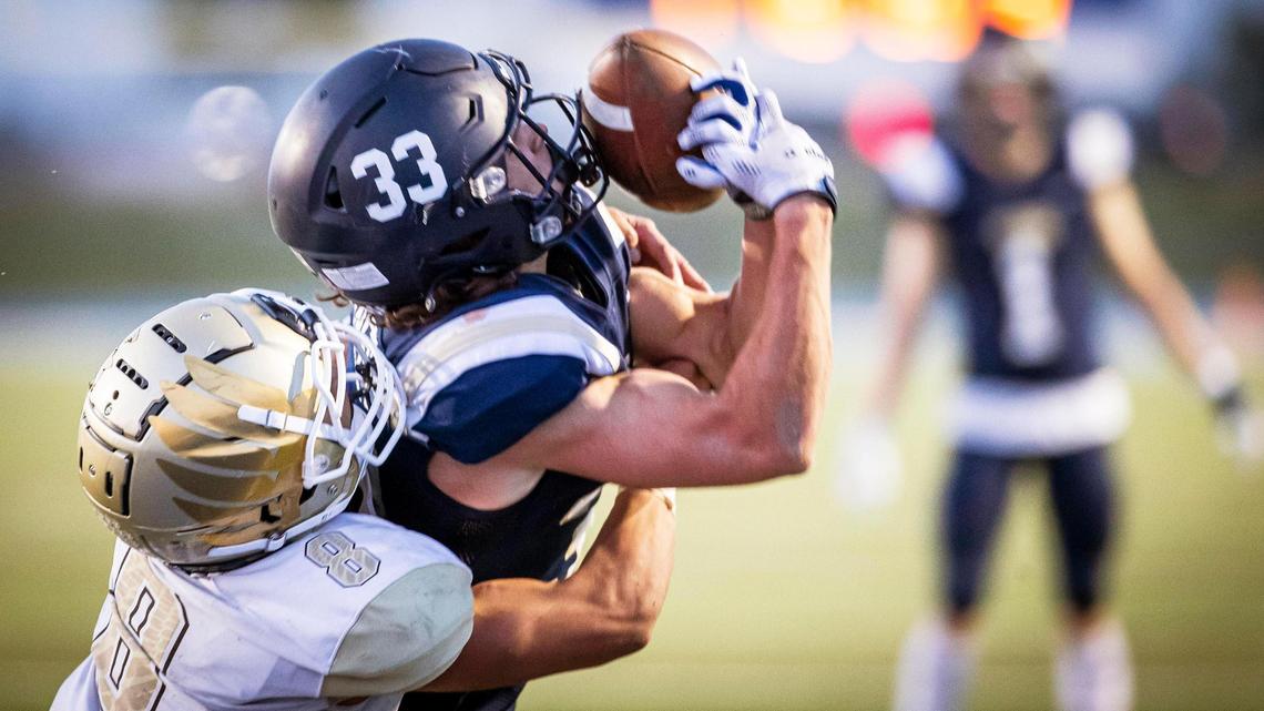 Middleton’s Tate Johansen pulls down a reception in the end zone defended by Vallivue’s Santiago Diaz on Friday at Middleton High School. The Vikings won 42-16.