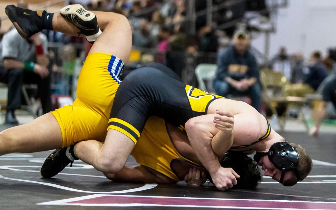 Bishop Kelly’s Jadon Skellenger pins Caldwell’s Gracin Go for the 152-pound title at the 4A District Three wrestling tournament Wednesday.