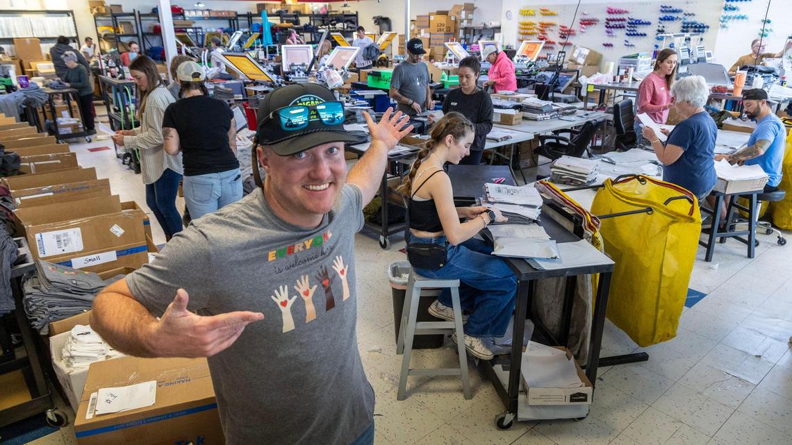 Shawn Wright, owner of Brigade Screen Printing, and staff work with a small army of volunteers printing “Everyone is welcome here” shirts.
