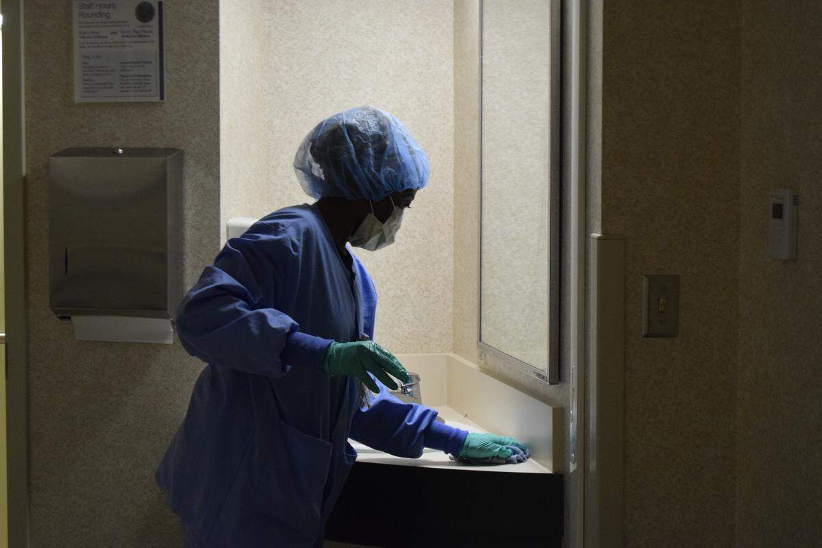 Nabila Hamid, an Environmental Services Technician and refugee from Sudan, cleans a room at St. Luke’s Meridian Medical Center in late April.