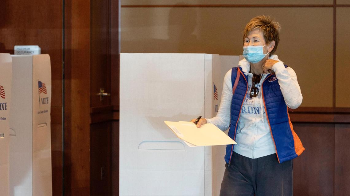 Julie Davis turns in her ballot after voting at the Boise State University Alumni and Friends Ballroom on Tuesday, Nov. 2, 2021.