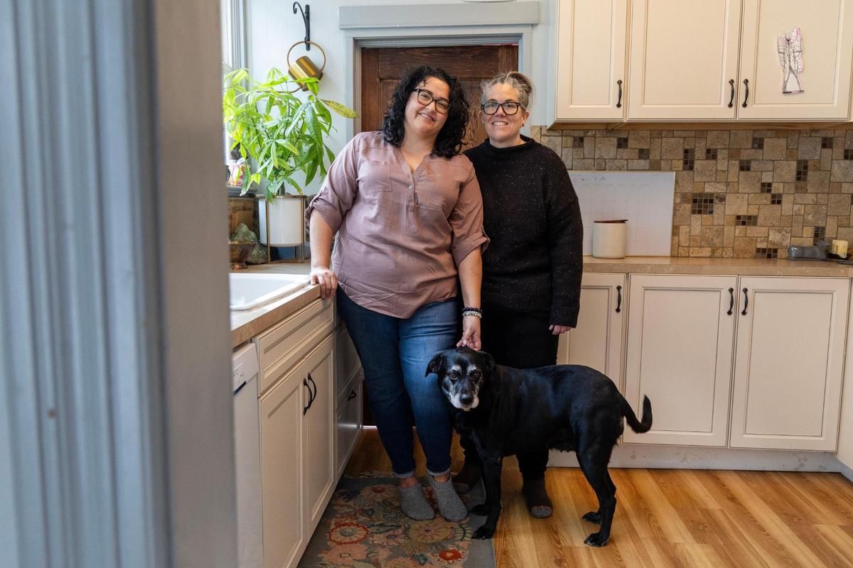Chelsea Gaona-Lincoln, left, and Van Beechler-Lincoln in their kitchen with their dog, Lily.