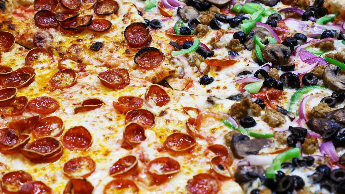 Pizza fresh out of the oven is prepped for diners at Anzalone Pizza, one of many food options at the new Warehouse Food Hall in downtown Boise.