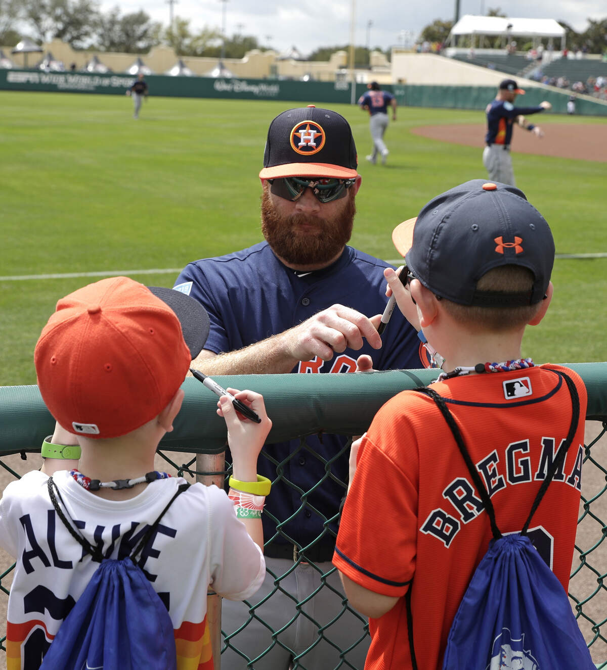 Twin Falls High grad Cy Sneed signs autographs with fans before an Astros spring training game.