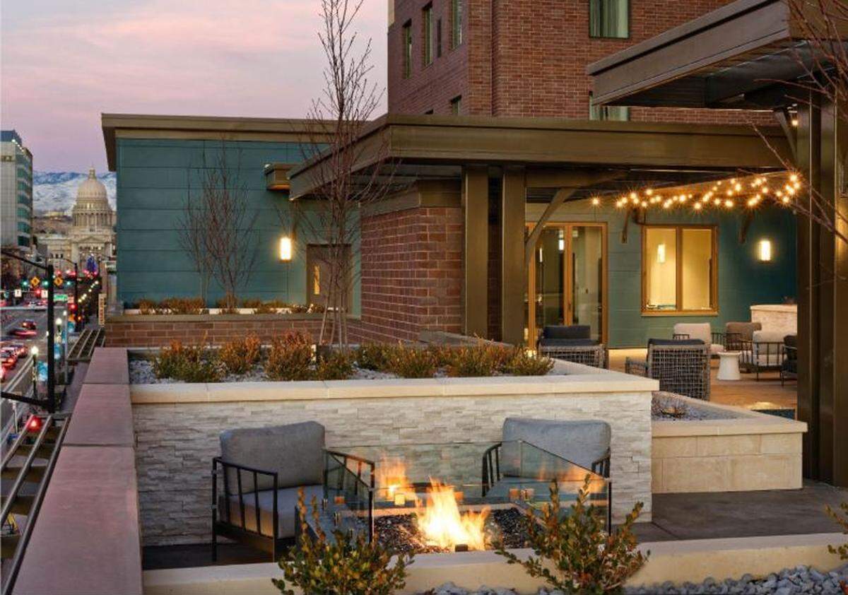 A fire pit warms the atmosphere at the roof-deck patio bar at the new Residence Inn by Marriott in Downtown Boise.