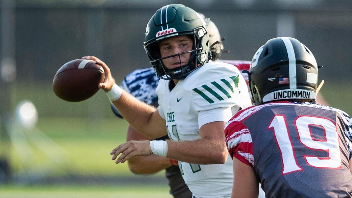 Eagle quarterback Brett Liljedahl finds a throwing lane despite pressure from Rocky Mountain’s Brody Swearhart last week at Rocky Mountain High.