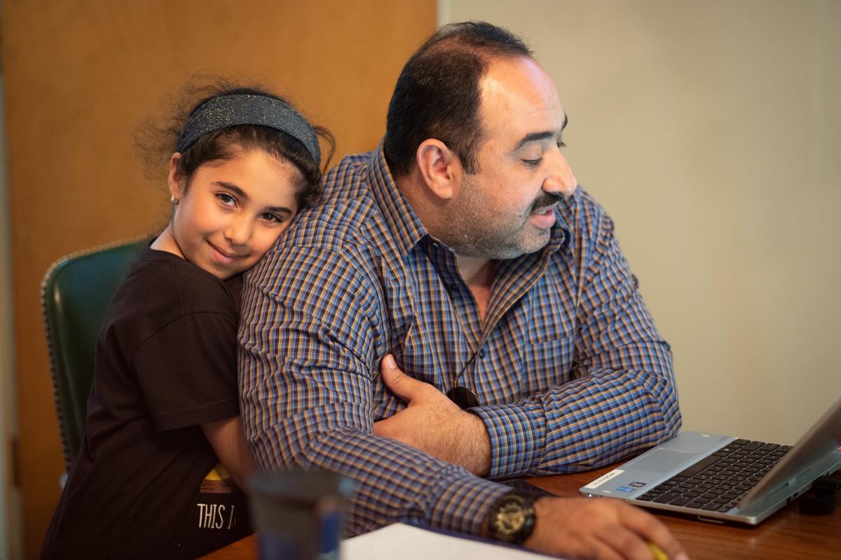 Salwan Swidan, a cardiologist in his native Iraq, studies for the U.S. Medical Licensing Examination with other refugee and immigrant doctors. His daughter, Deema, waits patiently during the weekly three-hour study sessions.