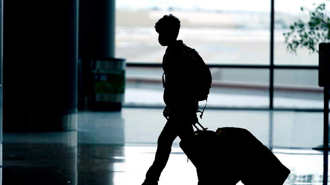 Travelers pass through Salt Lake City International Airport Monday, Dec. 27, 2021, in Salt Lake City.