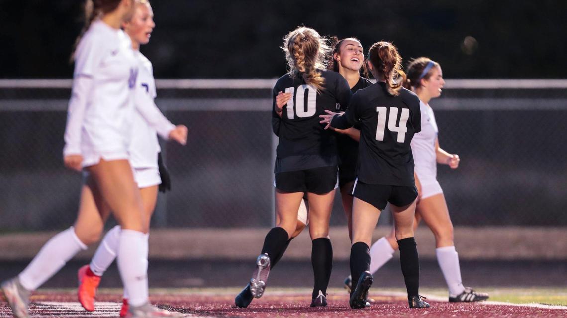 Rocky Mountain teammates celebrate Nadia Kincaid’s (center) first goal against Timberline in the 5A SIC District Three Tournament championship Wednesday at Centennial High.