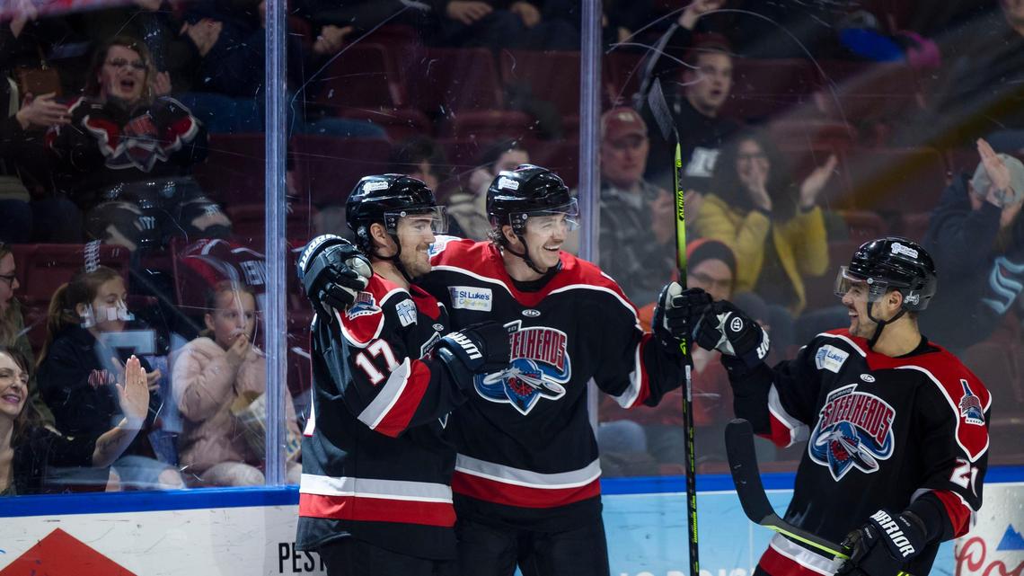 Idaho Steelheads forward Ty Pelton-Byce (17) celebrates a goal against the Kansas City Mavericks with teammates Cody Haiskanen, center, and Demetrios Koumontzis on Wednesday at Idaho Central Arena in downtown Boise.