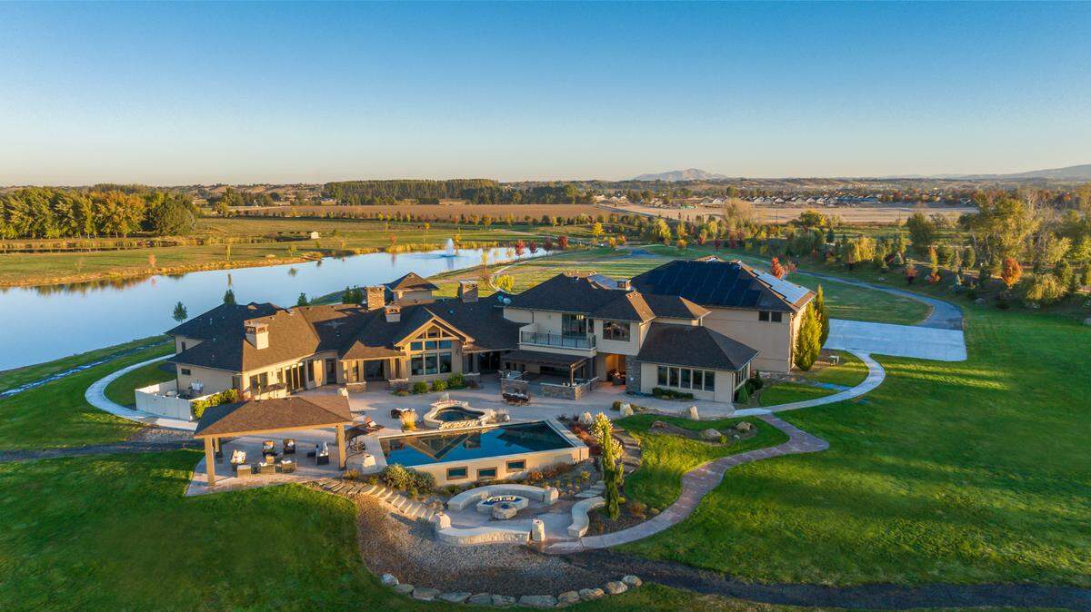 The $6.2 million home Brett Hughes sold sits near the Boise River and includes multiple fire pits, an outdoor area for hosting and a cooking-area.