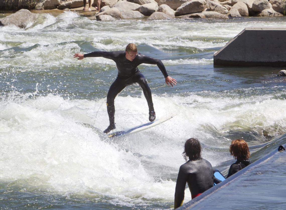 Perhaps the biggest reason for the popularity of the new businesses and high-end homes opening in Garden City’s Waterfront District is their promixity to the Boise Whitewater Park, accessible by footbridge. Boise Parks and Recreation wave technician Paul Primus surfs on a wave he helped shape.