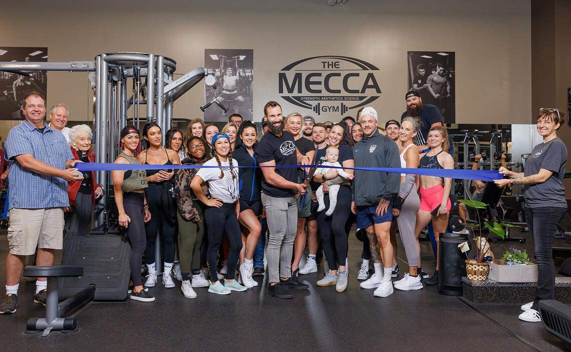 Mecca Gym CEO Eric Cafferty cuts the ribbon during a ceremony for a new location in Meridian.