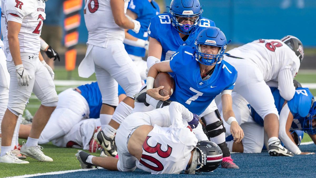 Emmett senior quarterback Ryder Scheibe follows his offensive to run for an 8-yard touchdown on a sneak in the first quarter Friday against Canyon Ridge. The Huskies opened their new artificial turf field with a 34-6 victory.