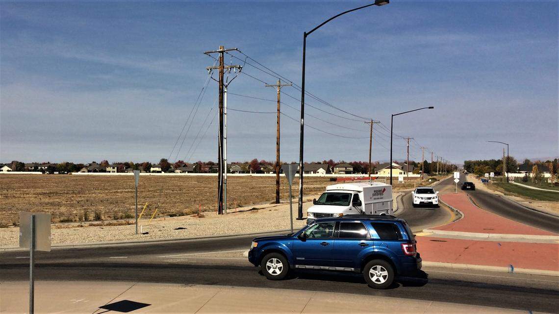 Drivers move through the roundabout at Eagle and Amity roads in South Meridian. Meridian Mayor Robert Simison, who lives in the Tuscany subdivision in the distance, wants the Ada County Highway District to replace the roundabout with a traditional traffic-light intersection.