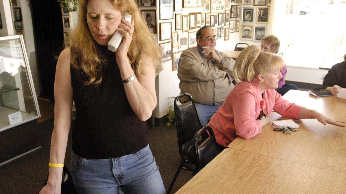 Tona Henderson receives a call from Sen. Mike Crapo's office at the Rumor Mill in Emmett where cancer survivors and family members gathered to view and discuss the National Academies of Science's report.