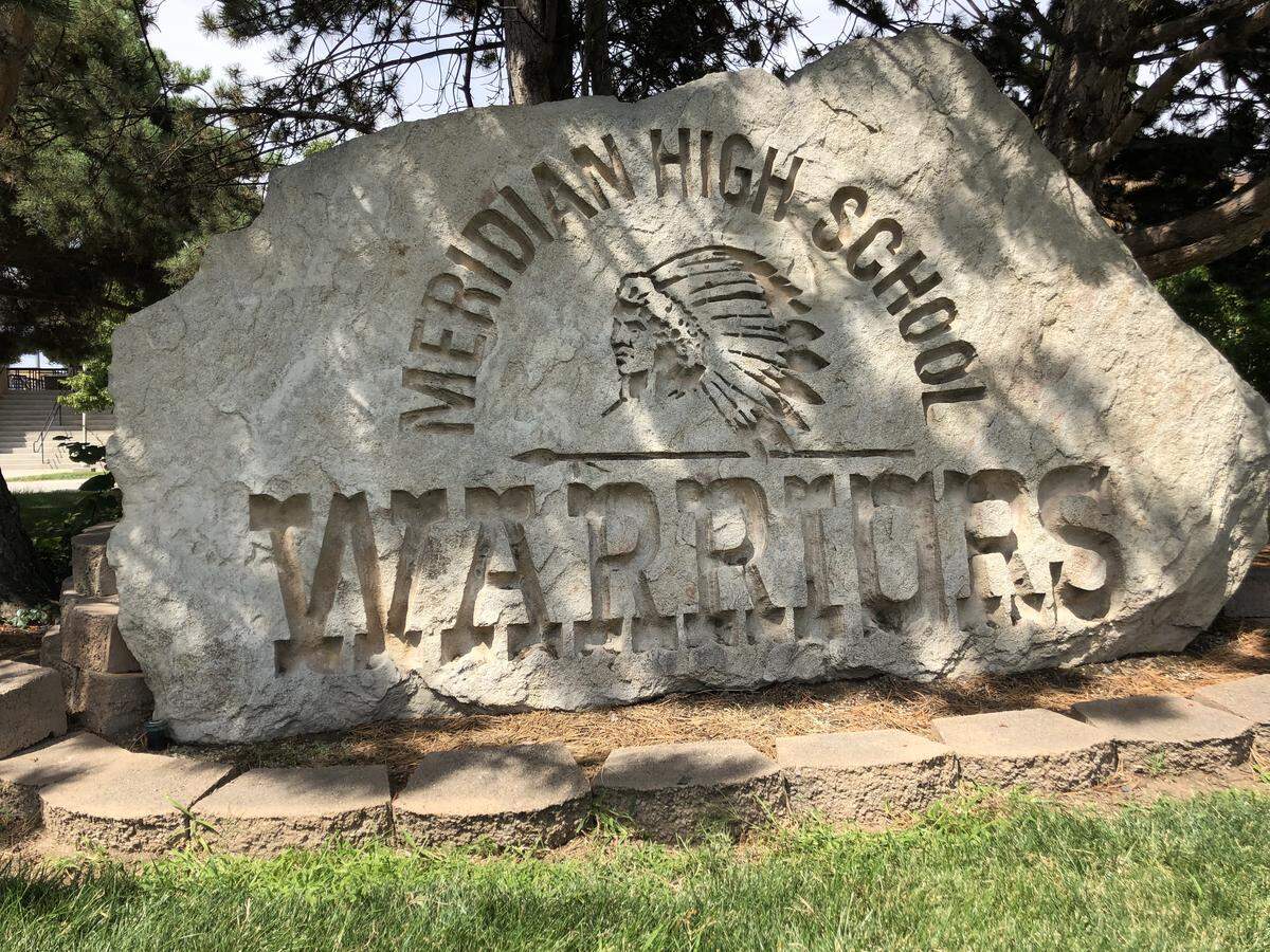 Featuring a Native American in a headdress, a rock donated by the class of 1990-91 stands in front of Meridian High School.