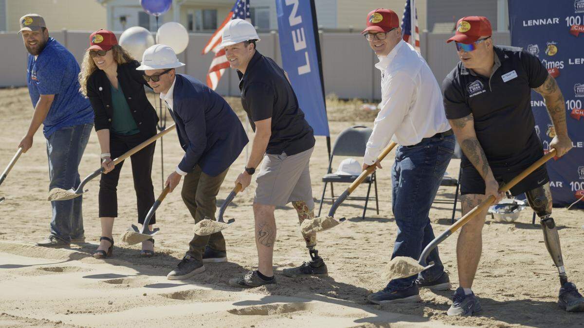 Aaron Bechtol, far left, and Sean Sexton, center right, break ground on the site of Sexton’s future home in Star alongside representatives from Helping A Hero, Lennar and Bass Pro Shops.