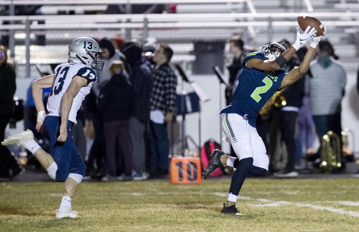 Mountain View wide receiver K.J. Lynch catches a long bomb behind Lake City’s Matt Angelo in the first round of the 5A state playoffs last week.