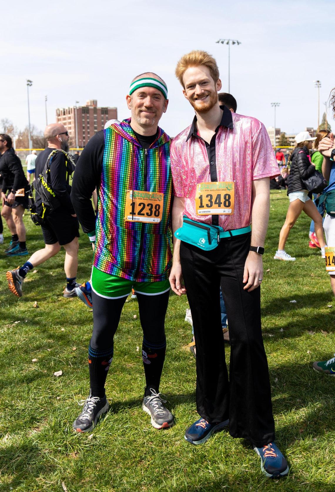 Dustin Bryant and Jake Coddington dressed in shiny, disco-ball-era-like attire for the “Stayin’ Alive” theme.
