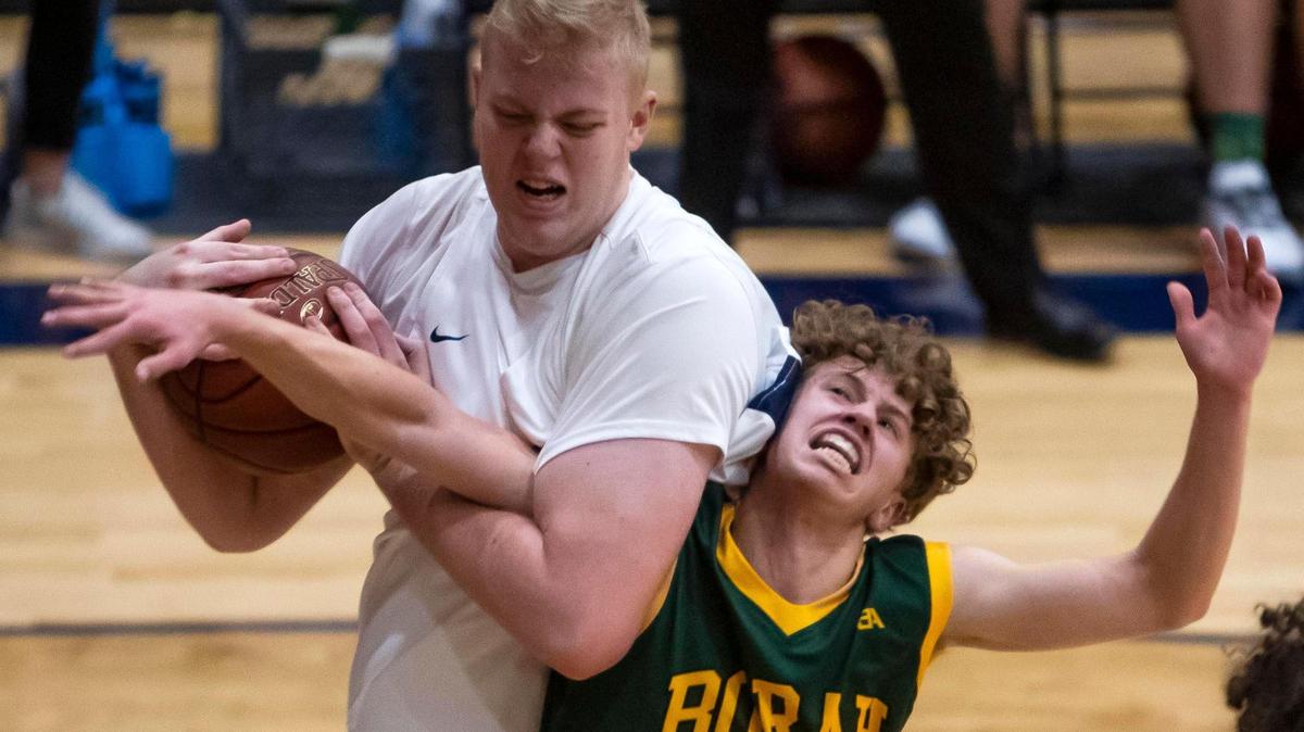 Meridian junior Brody Rowbury grabs a rebound from Borah’s Luke Hoetker during the first half of an 5A SIC boys basketball game Friday, Jan. 31, 2020 at Meridian High School.