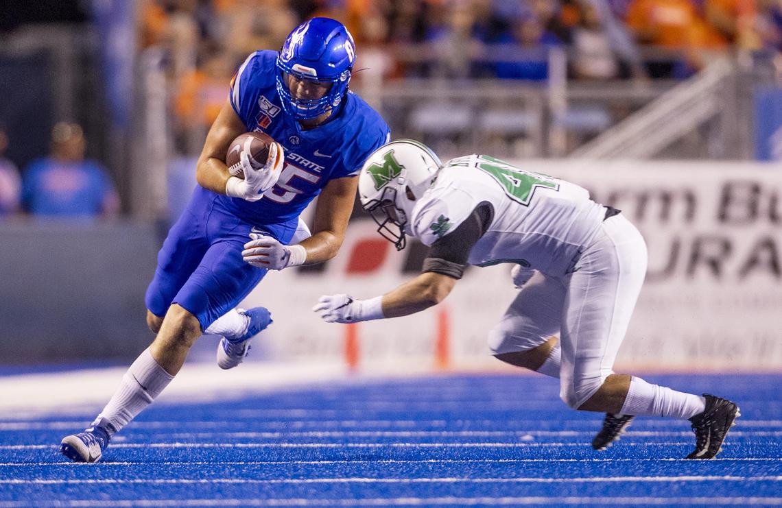 Boise State tight end John Bates (85) runs for extra yards after a catch before being tackled by Marshall linebacker Domenick Murphy (40) Friday, Sept. 6, 2019 at Albertsons Stadium in Boise.