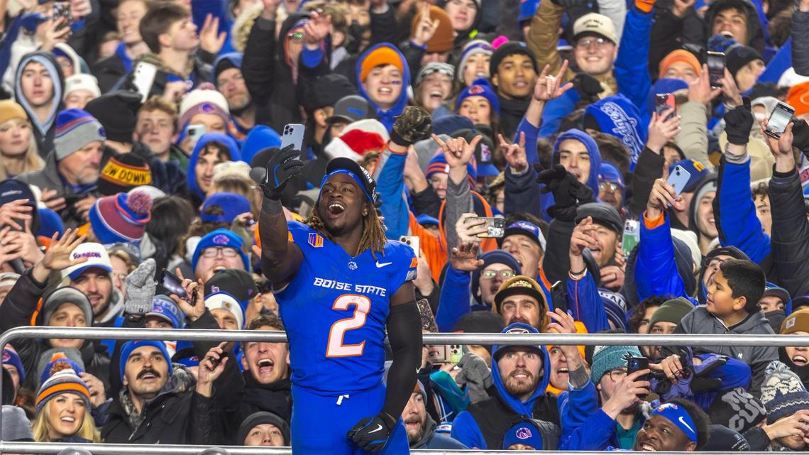 Boise State running back Ashton Jeanty enjoys the moment and takes selfies with fans after the Broncos defeated UNLV 21-7 to win the Mountain West championship on Friday night.