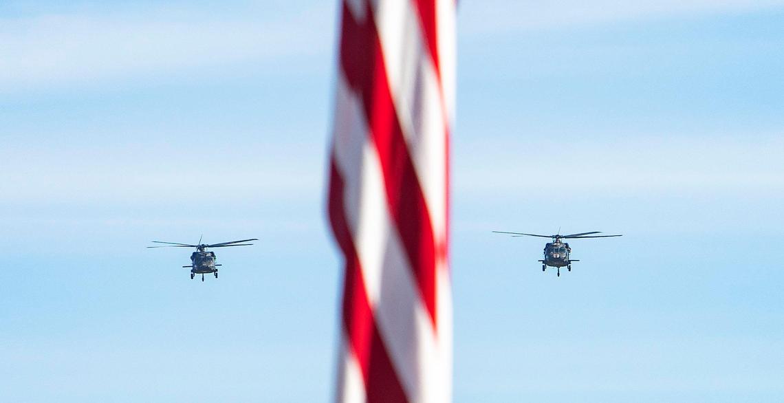 Two UH-60 Black Hawks fly over a Memorial Day observance event at the Idaho Veterans Cemetery on May 29, 2021.