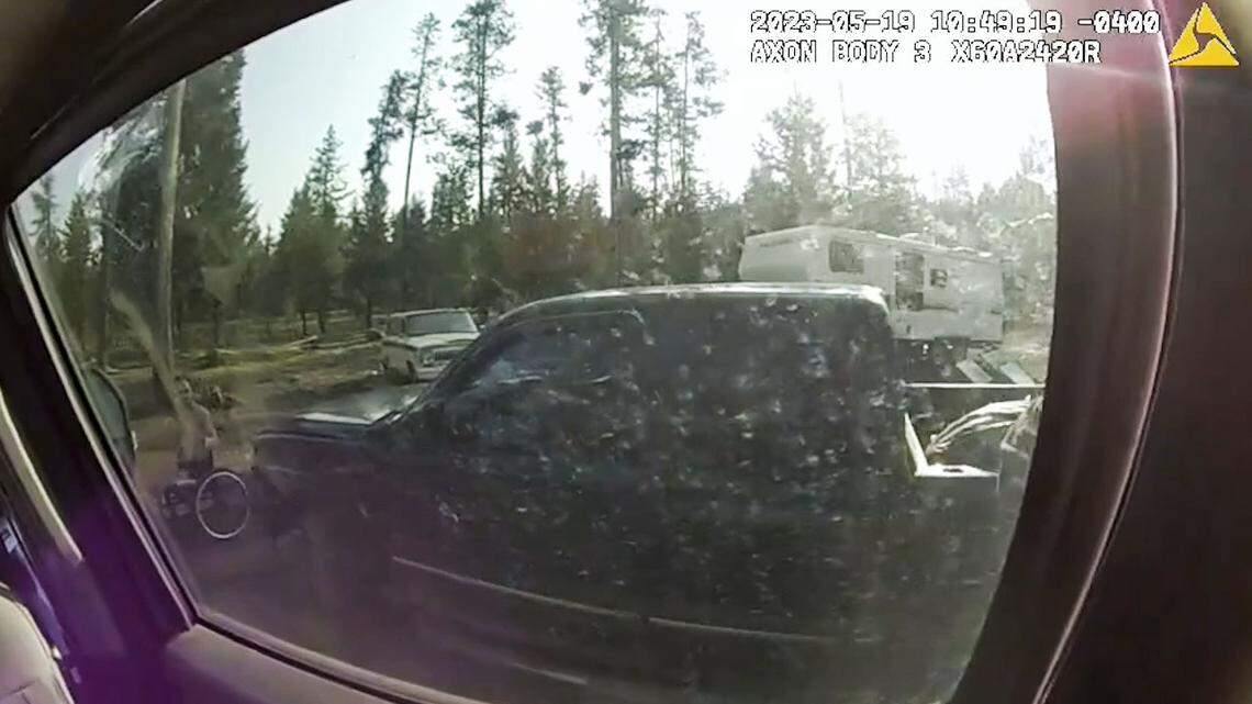 Through the window of federal agents’ vehicle, Brook Roberts can be seen holding a gun.