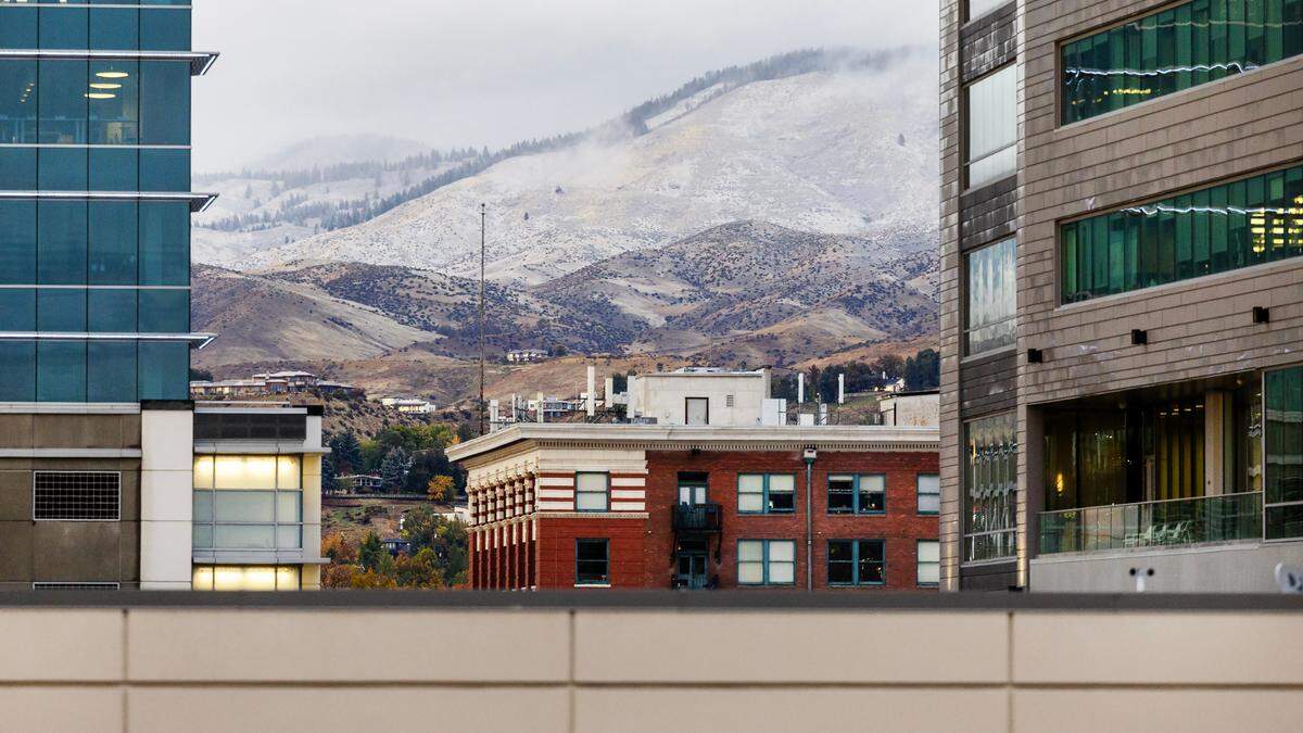 A wintery mix of precipitation falls in downtown Boise with light snow dusting the foothills at higher elevation, Wednesday, Oct. 25, 2023.