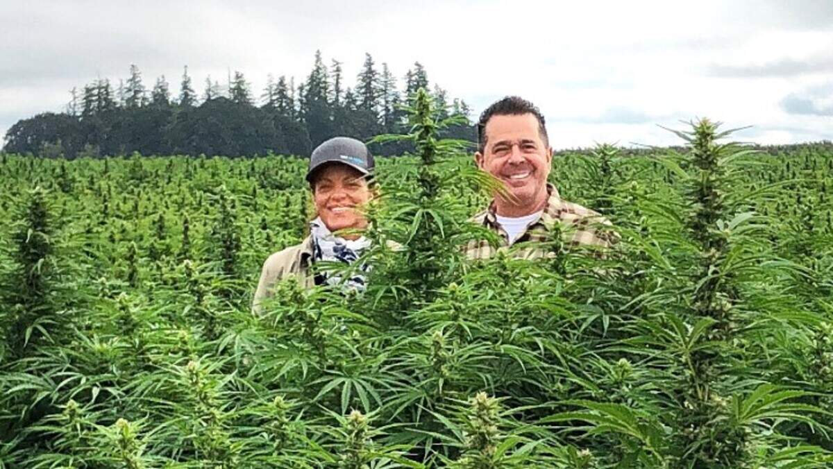 Paul Frantellizzi and his wife and business partner, Pamela Peters, stand in a hemp field in Oregon, where plants supply the ingredients for products from The Blissful Plant.