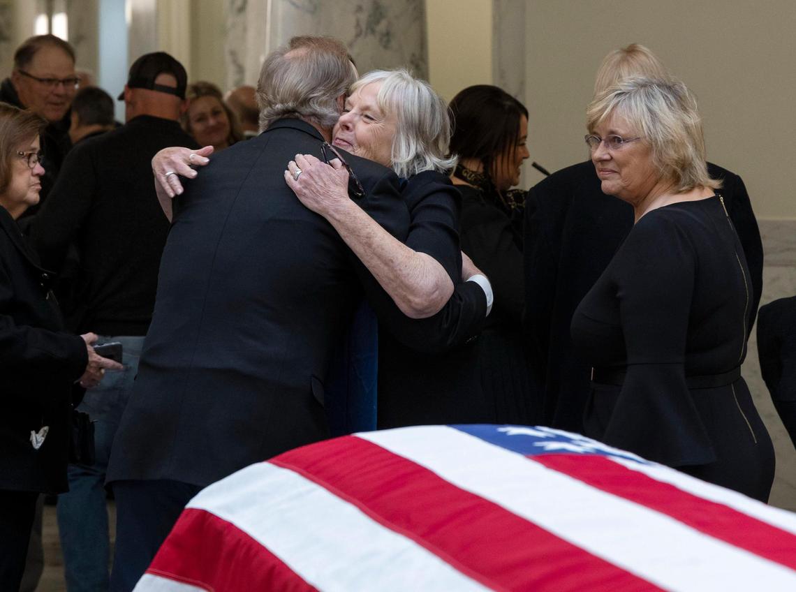 Francee Batt receives a hug from former Idaho Gov. Dirk Kempthorne after a ceremony honoring her husband, Gov. Phil Batt, who served as governor from 1995 to 1999. An honor guard transferred Gov. Batt to the Idaho Statehouse, Thursday, March 9, 2023, where he would lie in state for a day.