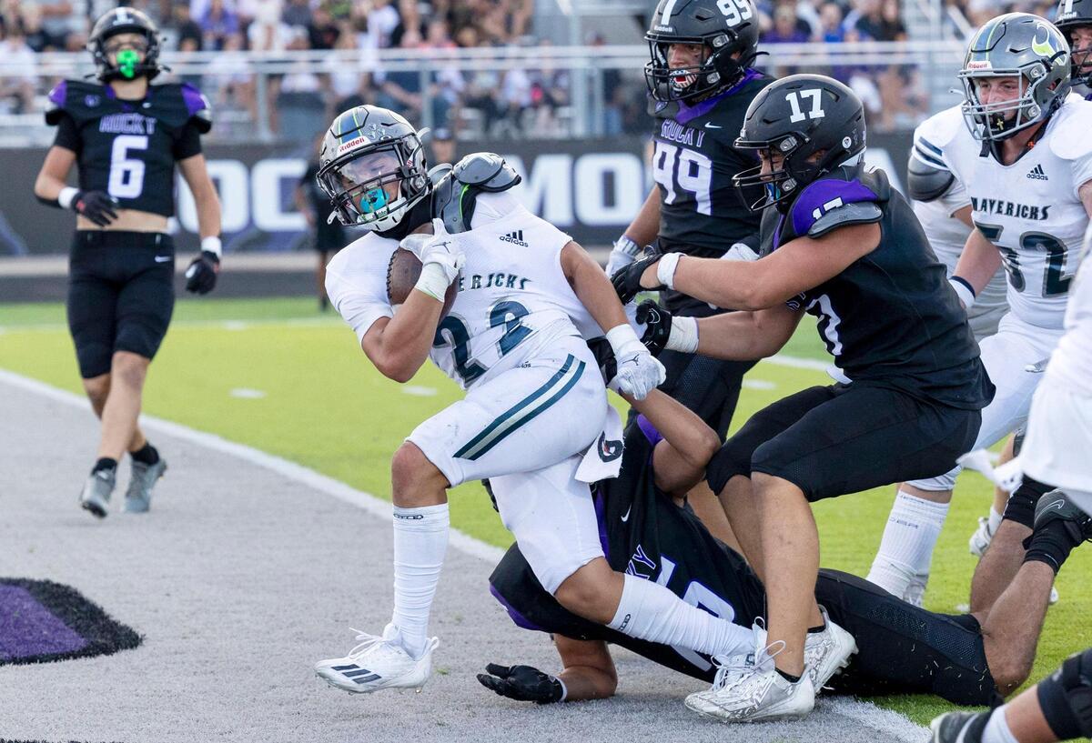Mountain View running back Valentin Gomez-Ricks drags several Rocky Mountain defenders into the end zone last fall.