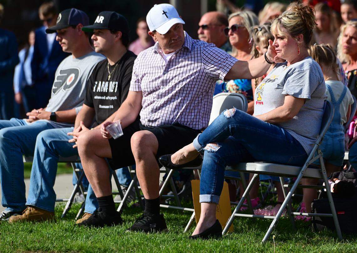 Steve Goncalves, left, wipes tears from the cheek of his wife, Kristi Goncalves, as the two parents of victim Kaylee Goncalves attend the dedication ceremony for the Vandal Healing Garden and Memorial at the University of Idaho on Aug. 21, 2024 in Moscow.