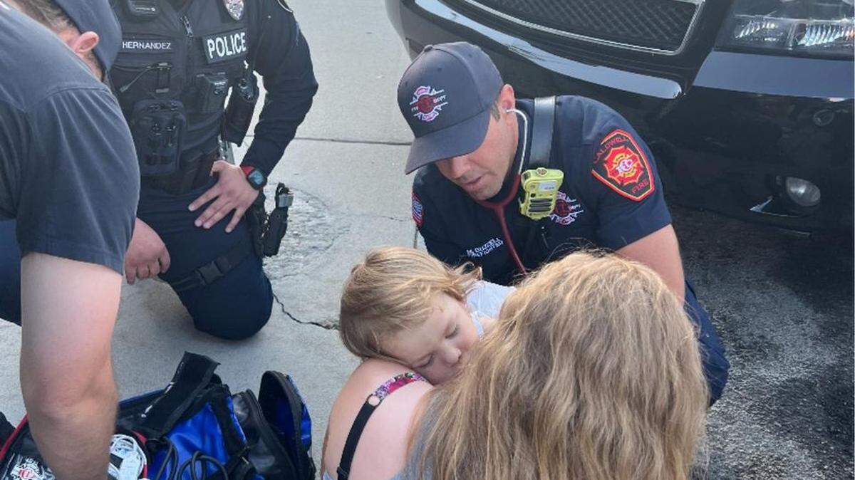 Police and fire department staff offer aid to a 2-year-old boy who experienced a medical emergency in Caldwell on Thursday.