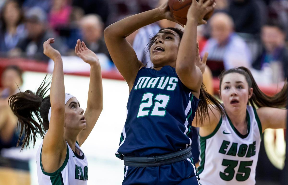Mountain View sophomore Naya Ojukwu scores in the post defended by Eagle’s Elise Boockholdt and Alex Stokoe (35) in the 5A state girls basketball tournament semi-finals Friday, Feb. 21, 2020 at Ford Idaho Center in Nampa.