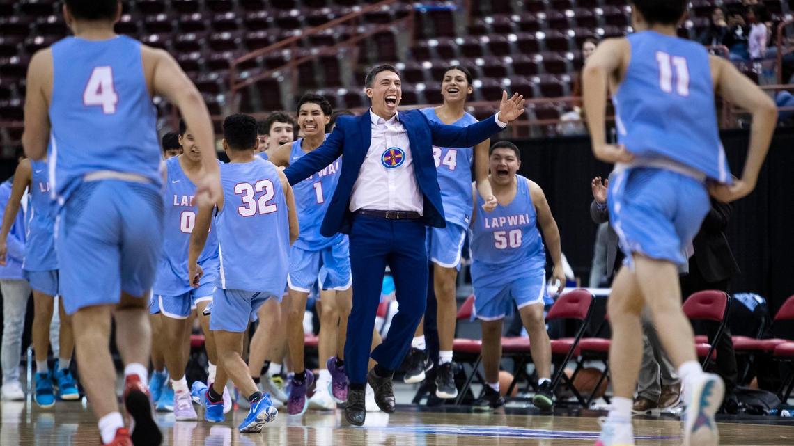 Lapwai coach Zachary Eastman and his boys basketball team celebrate at the buzzer after beating Riverstone 82-60 in the 1A Division I championship game.