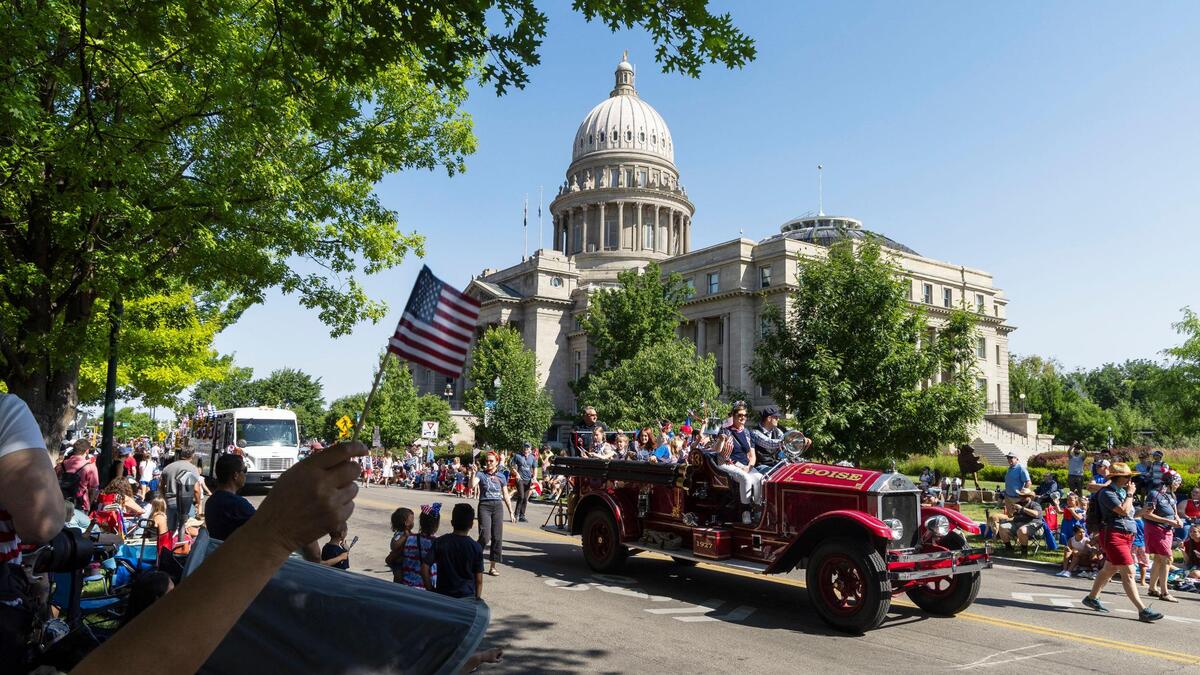 A red, white and blue Independence Day Parade winds through downtown Boise in this 2023 photo. State employees can expect a five-day weekend in celebration of America 250.