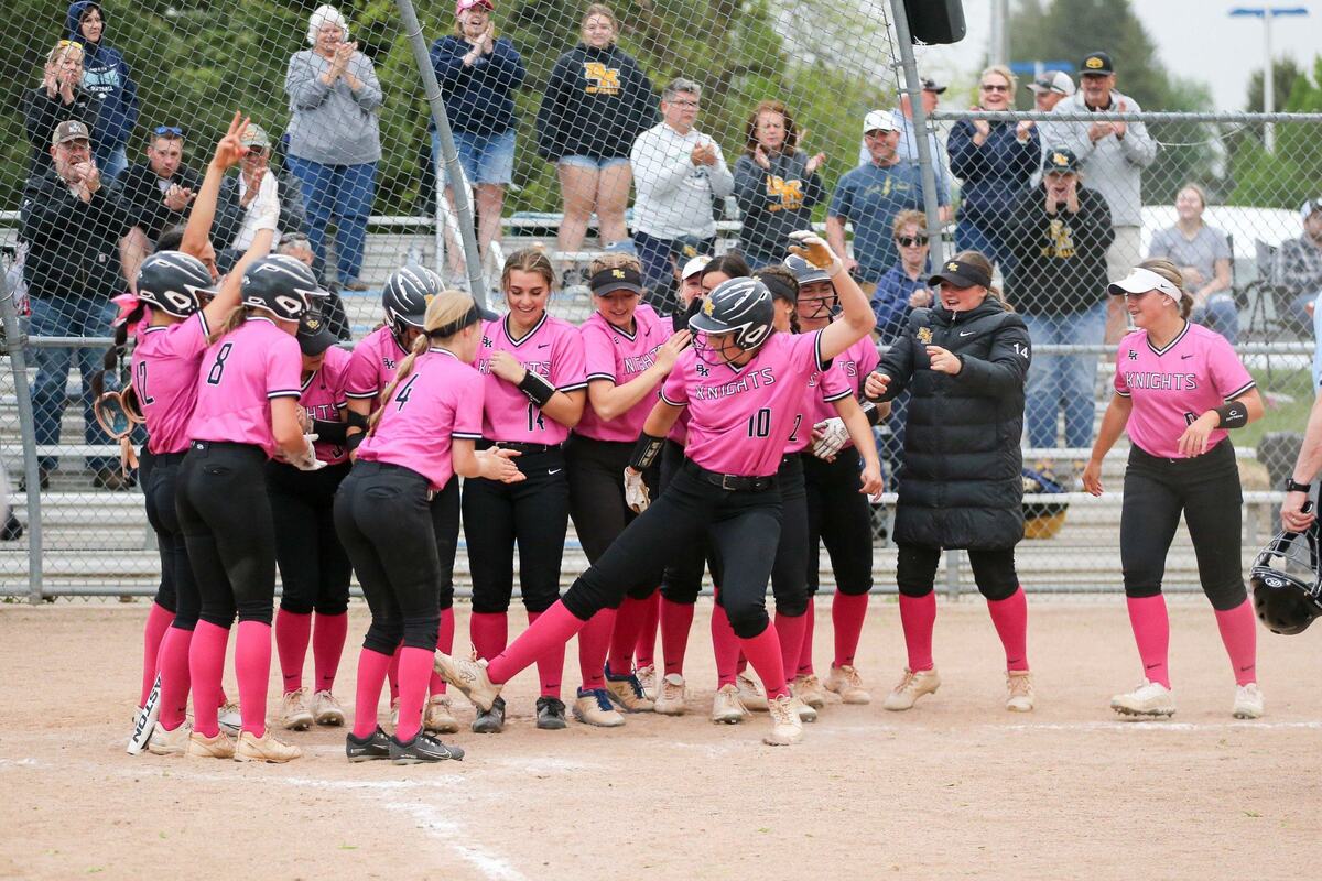Lauren Fettic celebrates with teammates after her second home run of the game, a two-run blast in the sixth inning, gave Bishop Kelly a 5-4 lead in its 4A state softball game Thursday at Coeur d’Alene High.
