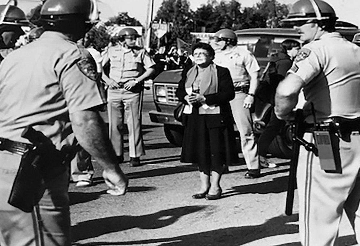 Leontine Kelly was arrested during the Good Friday Livermore Weapons Laboratory protest in 1985 in Livermore, California. She is seen facing off against uniformed officers during that protest.