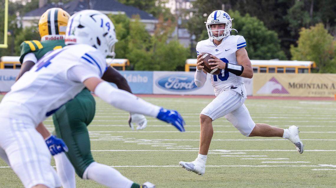 Timberline senior quarterback looks to pass to teammate junior wide receiver Hayden Hills in the first quarter of their football game against Borah at Dona Larsen Park, Friday, August 29, 2025.