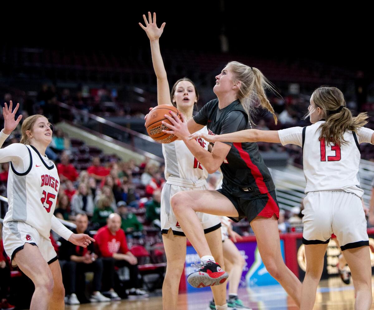 Owyhee’s Riley Beck draws a foul on Boise’s Avery Patricco while driving to the hoop in the first round of the 5A girls basketball state tournament last season at the Ford Idaho Center in Nampa.