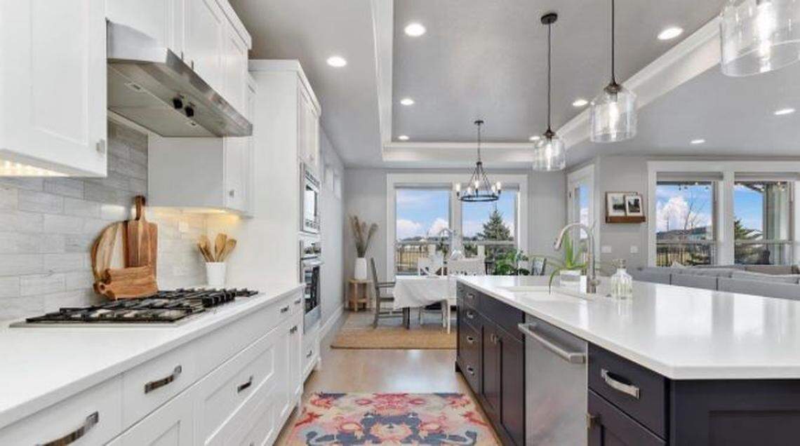 The gourmet kitchen of Shane Speakman’s house features a gas stove, an island and quartz counters.