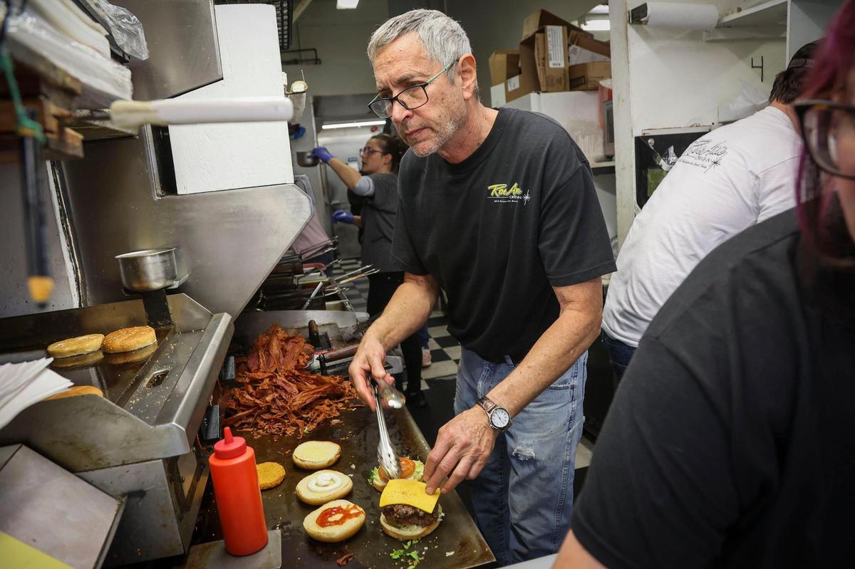 Bob Clausen and his crew at Emmett, Idaho’s, iconic Roe-Ann drive-in cook burgers and fries and fill orders during a noon-hour rush — a scene repeated for about 70 years at the family business.