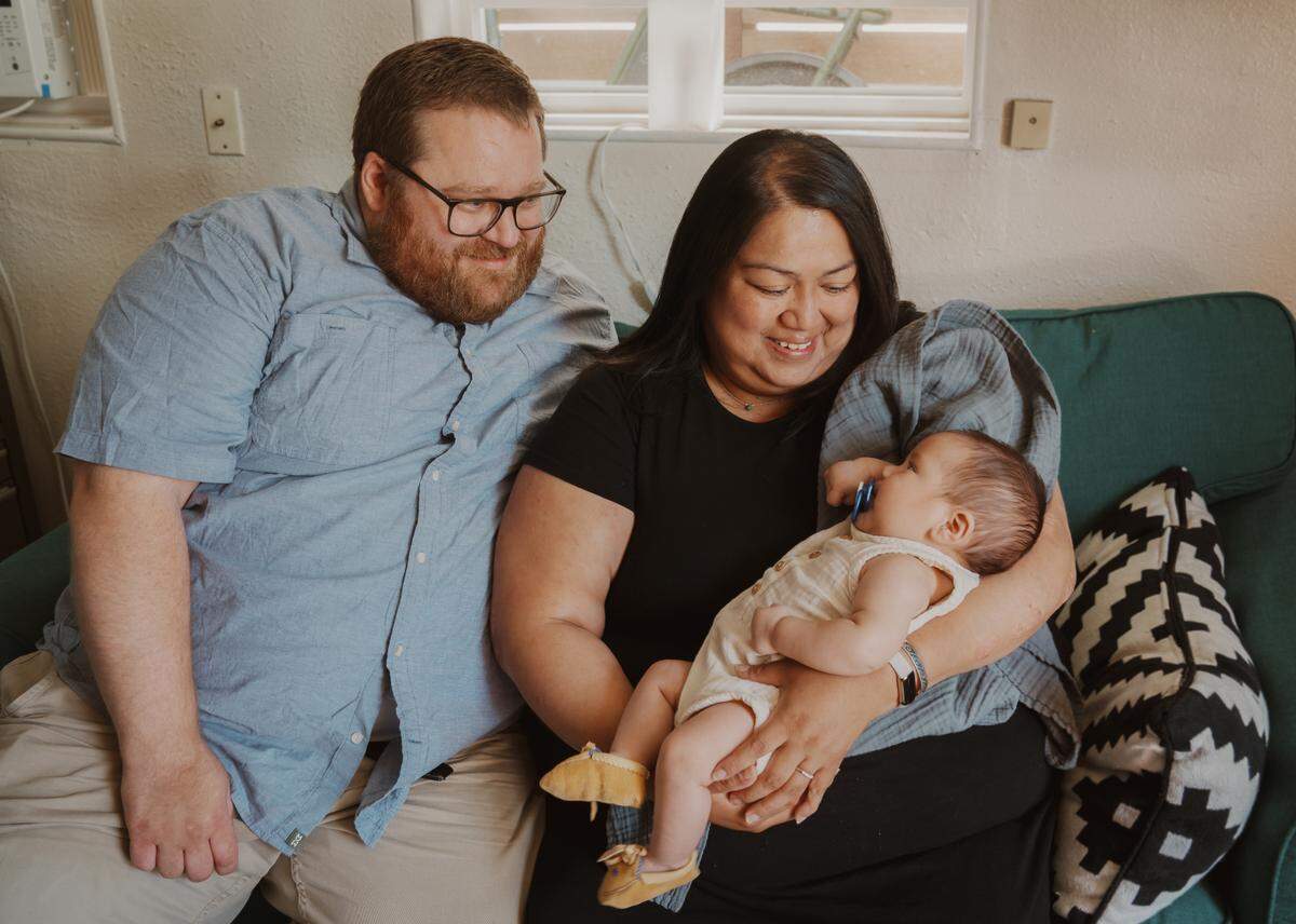 New parents Shannon Kopelva and Andy Piehl with baby Graham in their home in downtown Seattle in July.