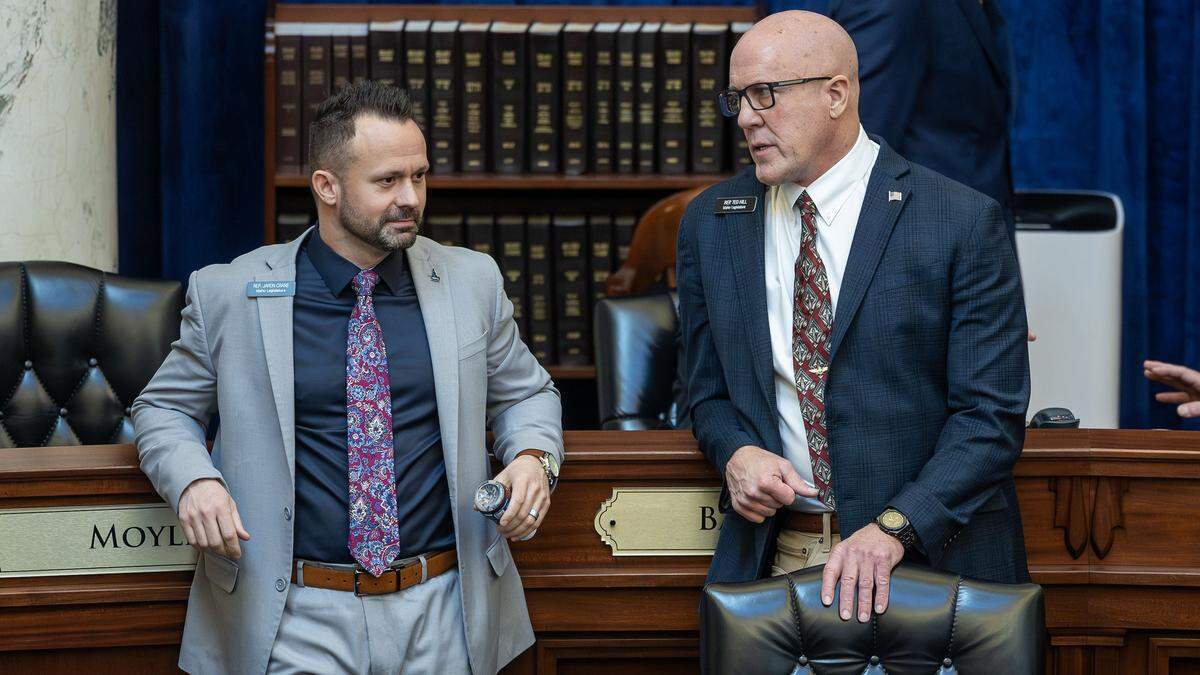 Rep. Ted Hill, R-Eagle, and Rep. Jaron Crane, right, R-Nampa, have conversation before the start of the day's business on he floor of the Idaho House of Representatives at the Statehouse in Boise, Thursday, Jan. 29, 2026.