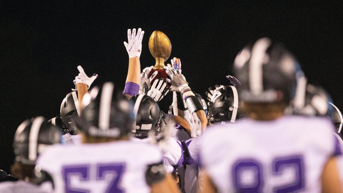 Rocky Mountain football players lift up the Herb Criner Bowl trophy for the fifth straight year Friday at Eagle.